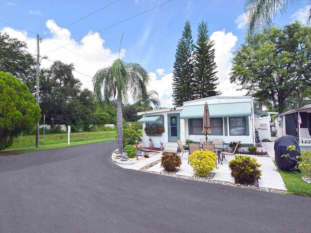 Mobile home with decorative landscaping at AVALON RV RESORT
