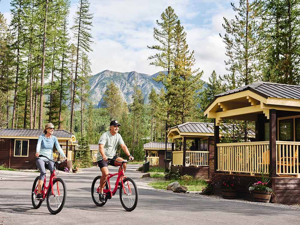 A couple riding their bikes at WEST GLACIER RV PARK & CABINS