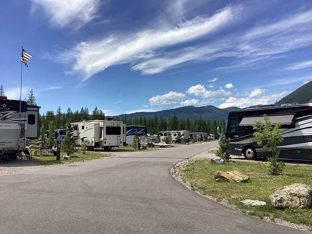 A paved road between RV sites at WEST GLACIER RV PARK & CABINS