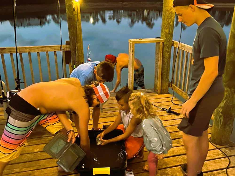 Children fishing off a deck at AHOY RV RESORT