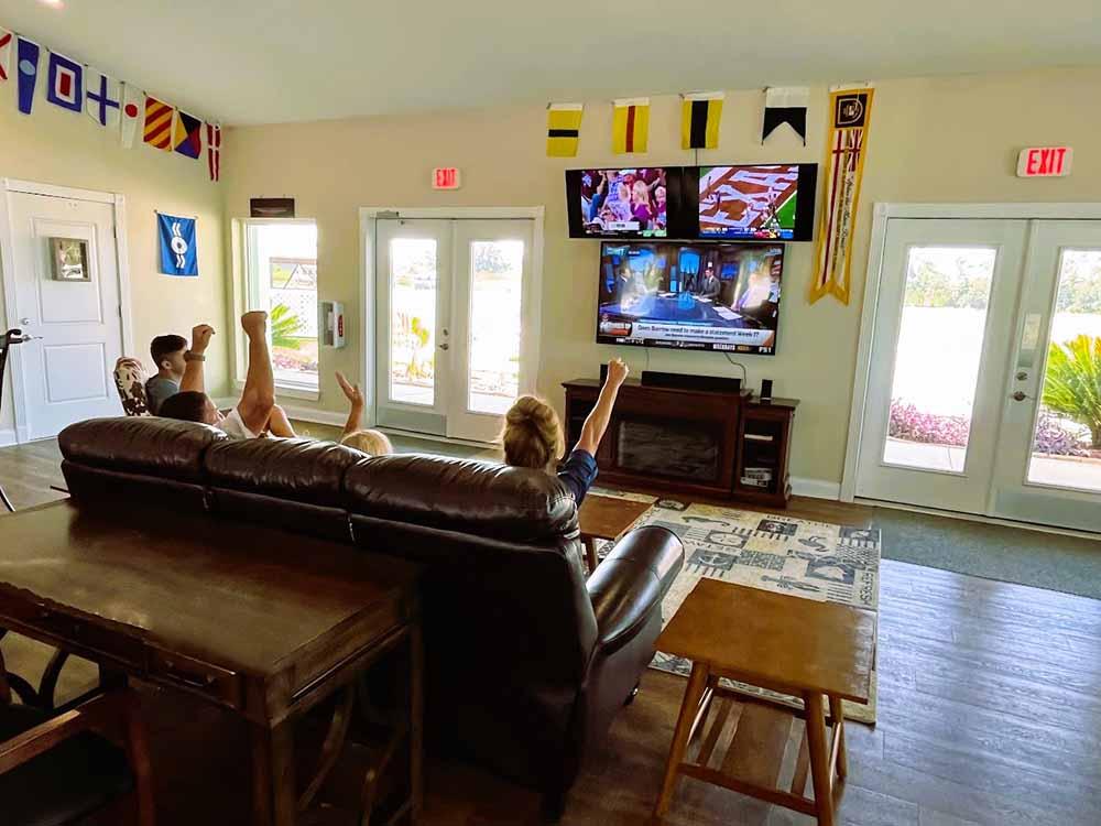 Guests watching a game on a flat screen at AHOY RV RESORT