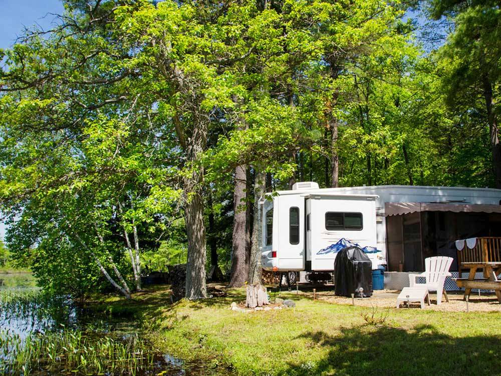 Trailer camping on the lake at TUXBURY POND RV CAMPGROUND
