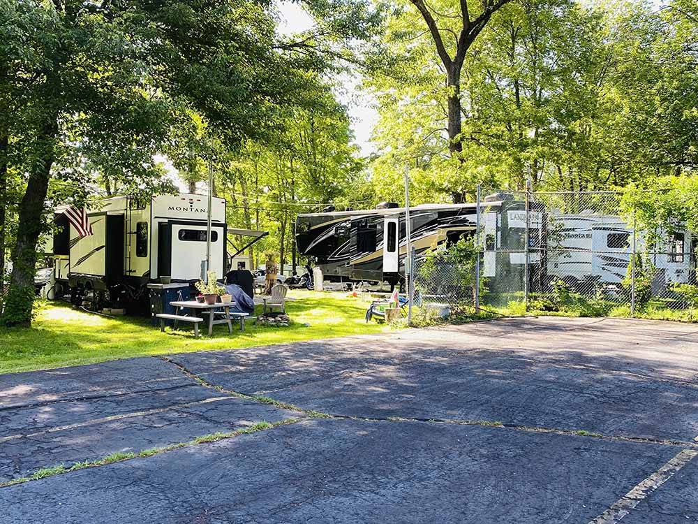 Grassy RV sites under trees at GENTILE'S CAMPGROUND