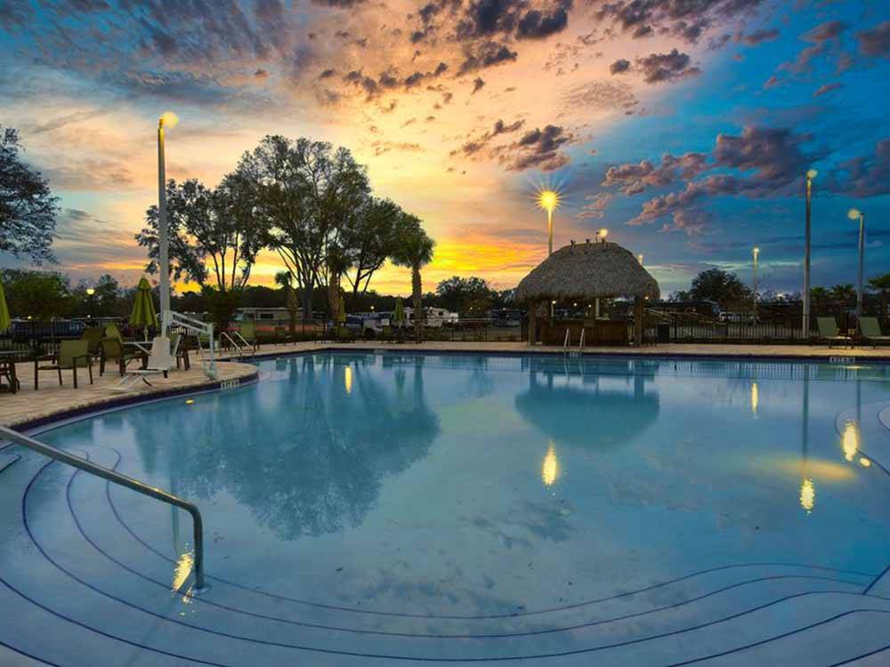The large swimming pool at dusk at SUNKISSED VILLAGE RV RESORT