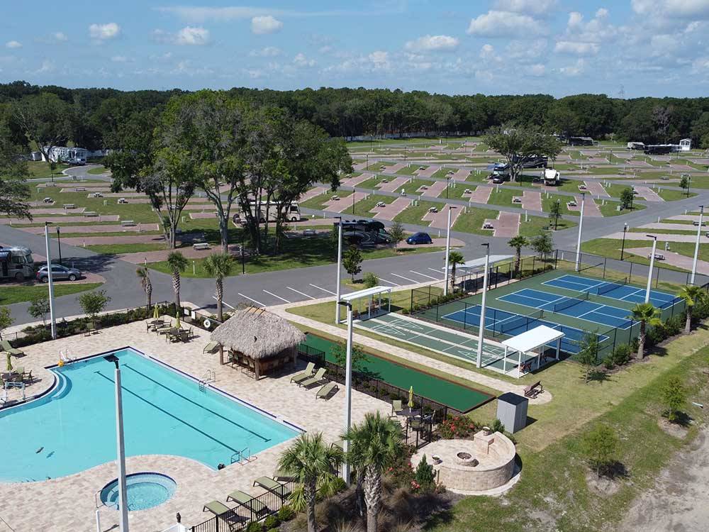 Aerial view of pool, tennis courts and RV camping area at SUNKISSED VILLAGE RV RESORT