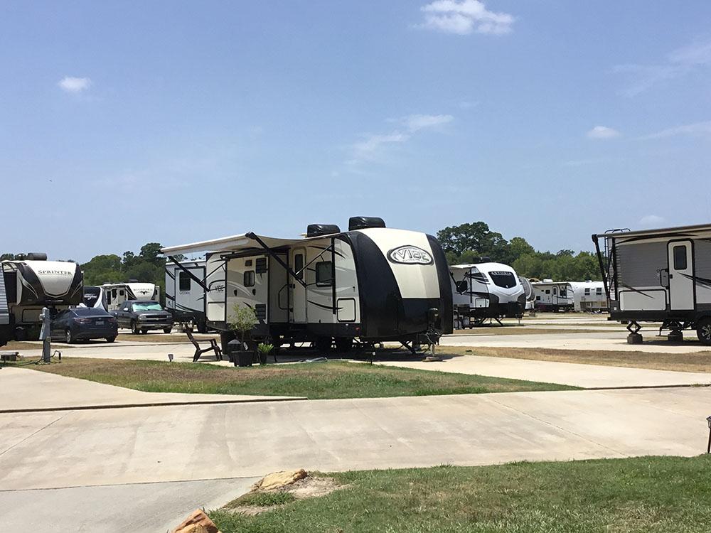 A travel trailer parked in a pull thru site at EAST FORK RV RESORT