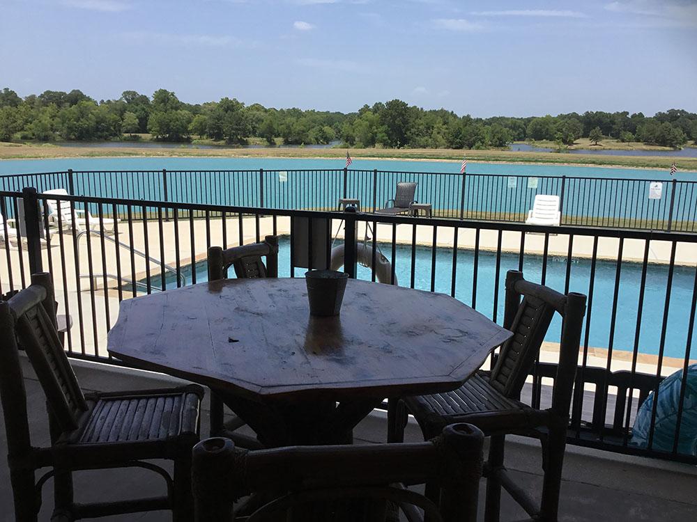 A table and chairs next to the swimming pool at EAST FORK RV RESORT
