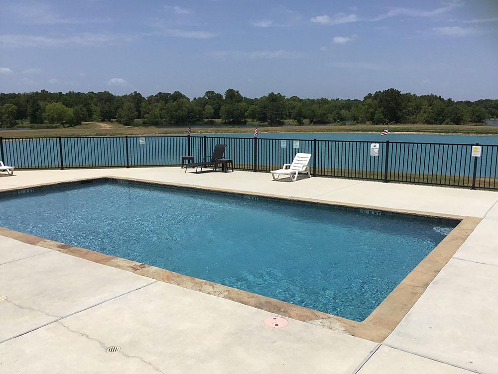 Lounge chairs in the swimming pool area at EAST FORK RV RESORT
