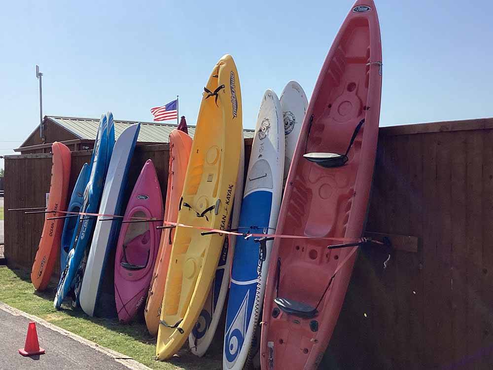 Different colored kayaks on the fence at DO DROP INN RV RESORT & CABINS