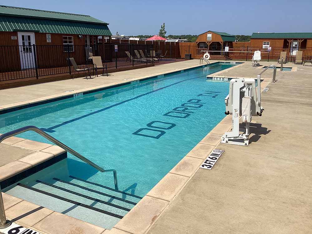 The swimming pool with park name on the bottom of it at DO DROP INN RV RESORT & CABINS