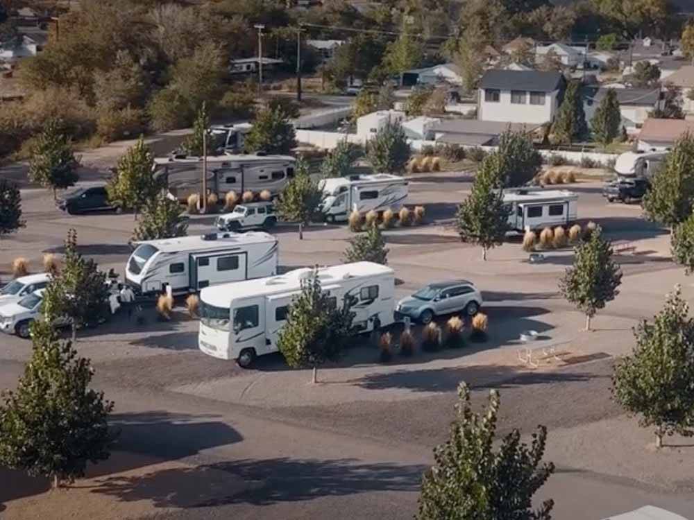 Aerial view of parked RVs and cars in sites at CASTLE GATE RV PARK & CAMPGROUND