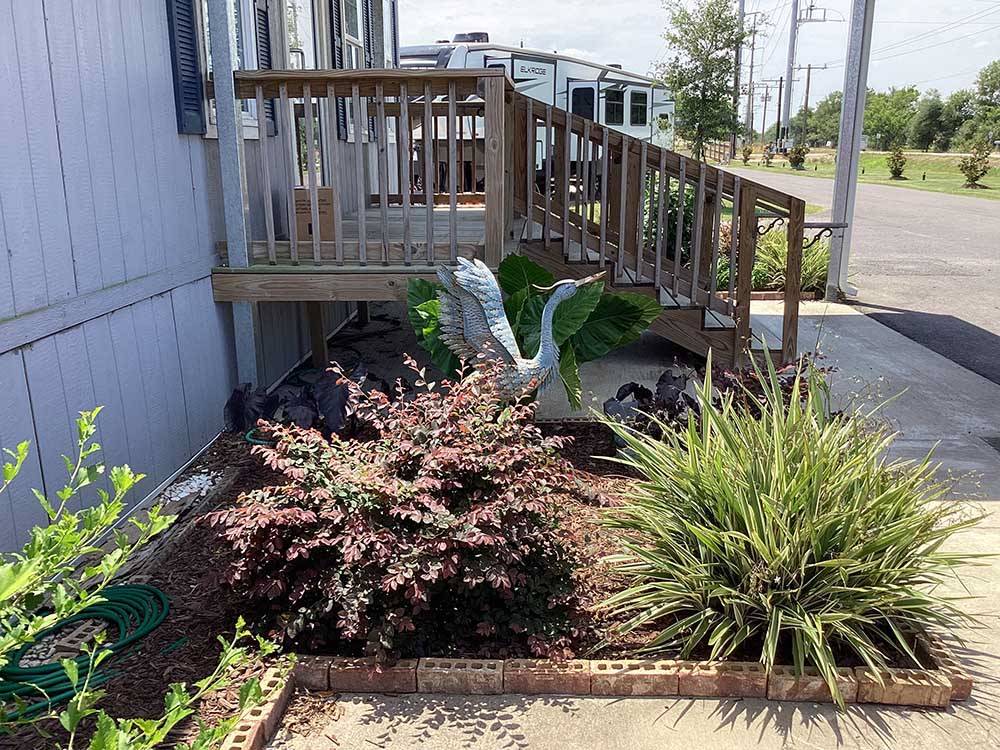 A statue of a blue heron in a planter at BLUE HERON RV PARK