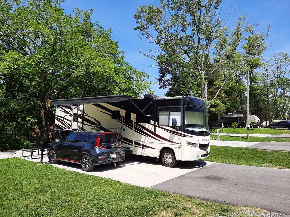 Motorhome parked in campsite at GATEWAY TO THE SMOKIES RV PARK & CAMPGROUND