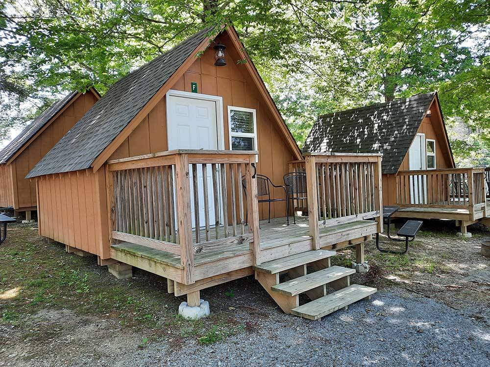 Cabins with front porches at GATEWAY TO THE SMOKIES RV PARK & CAMPGROUND