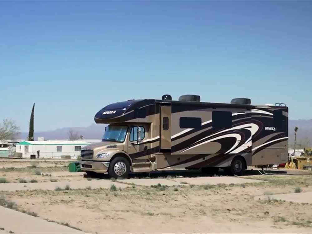 A motorhome in an RV site at RANCHO SAN MANUEL MOBILE HOME & RV PARK