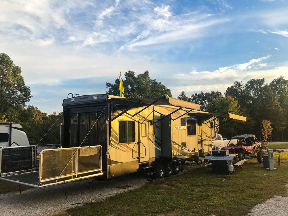 A fifth wheel toy hauler parked in a gravel site at BIGFOOT ADVENTURE RV PARK & CAMPGROUND
