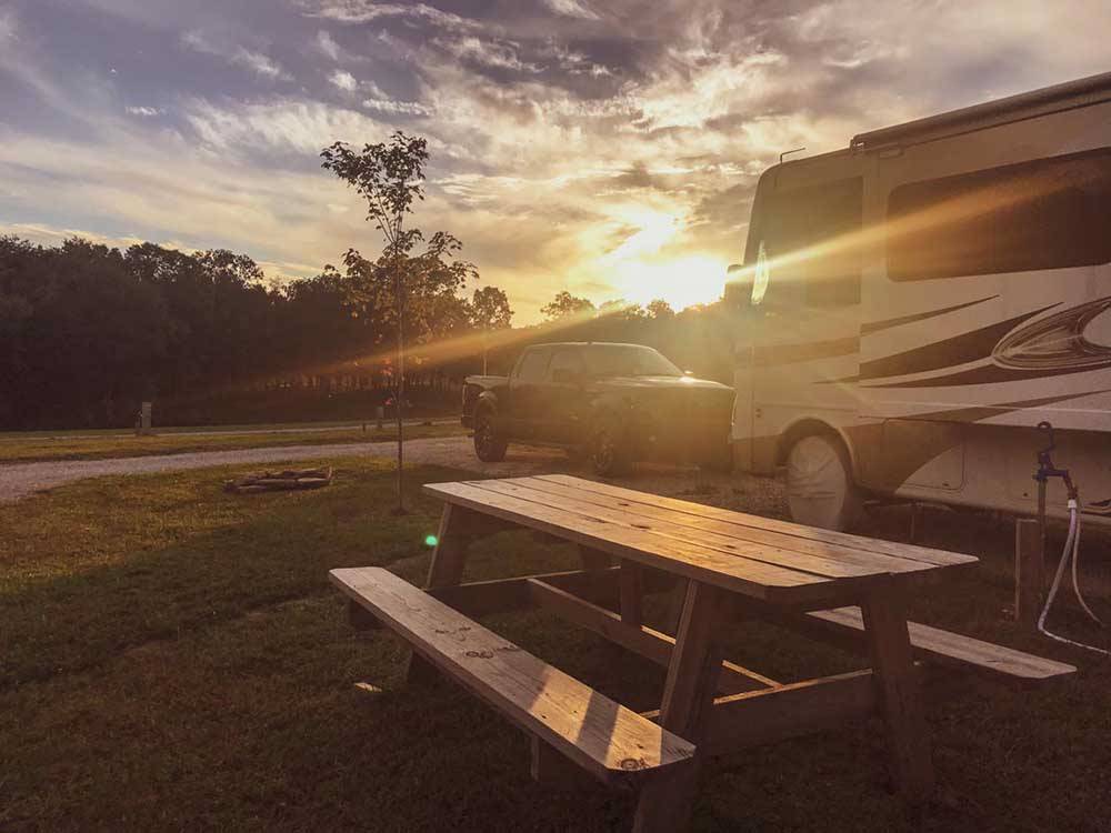 A picnic table next to a motorhome at BIGFOOT ADVENTURE RV PARK & CAMPGROUND