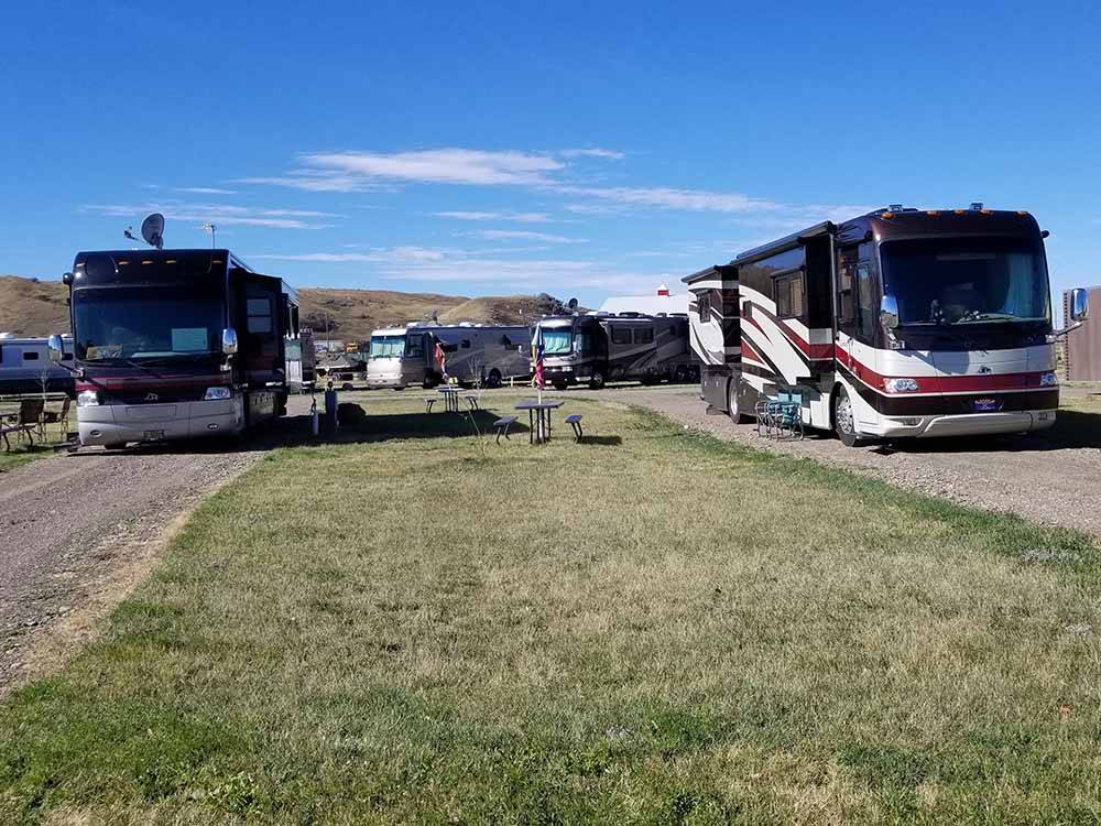 Large motorhomes in gravel RV sites at HANSEN FAMILY CAMPGROUND & STORAGE