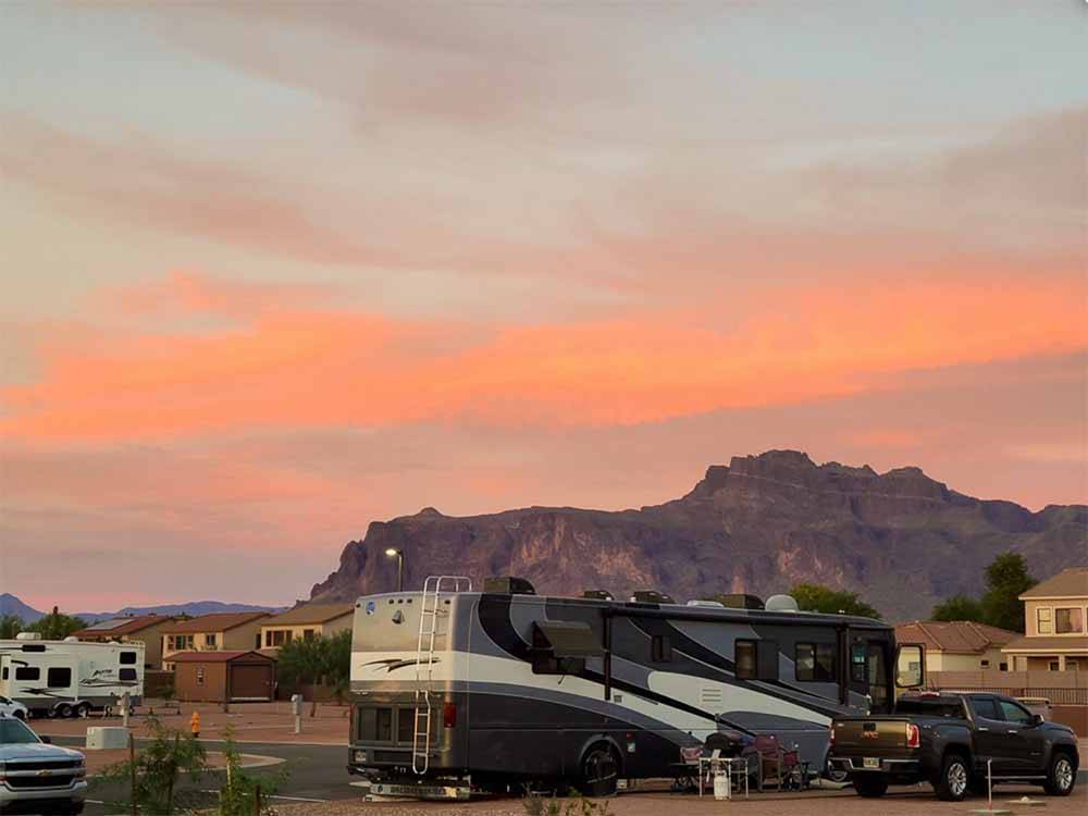 A motorhome parked in a site at sunset at CAMPGROUND USA RV RESORT