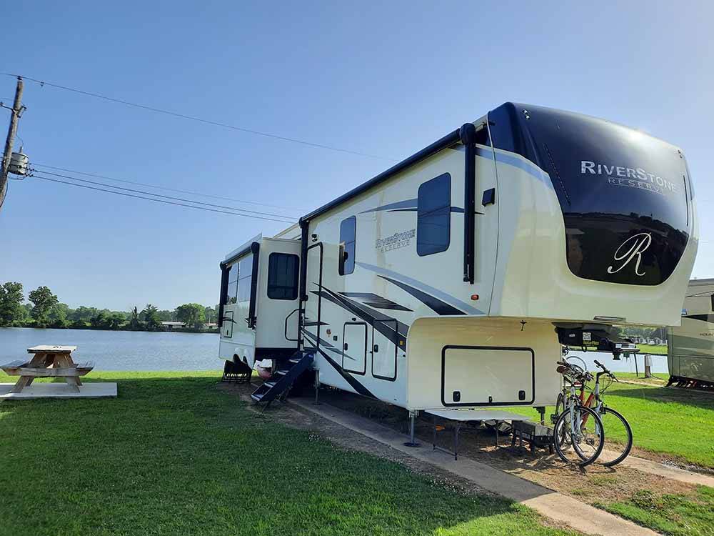 A fifth wheel trailer by the water at COOK'S LAKE RV RESORT & CAMPGROUND