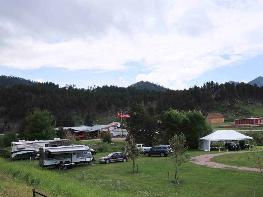 Sites with trailers and large shade tent at FIREHOUSE CAMPGROUND