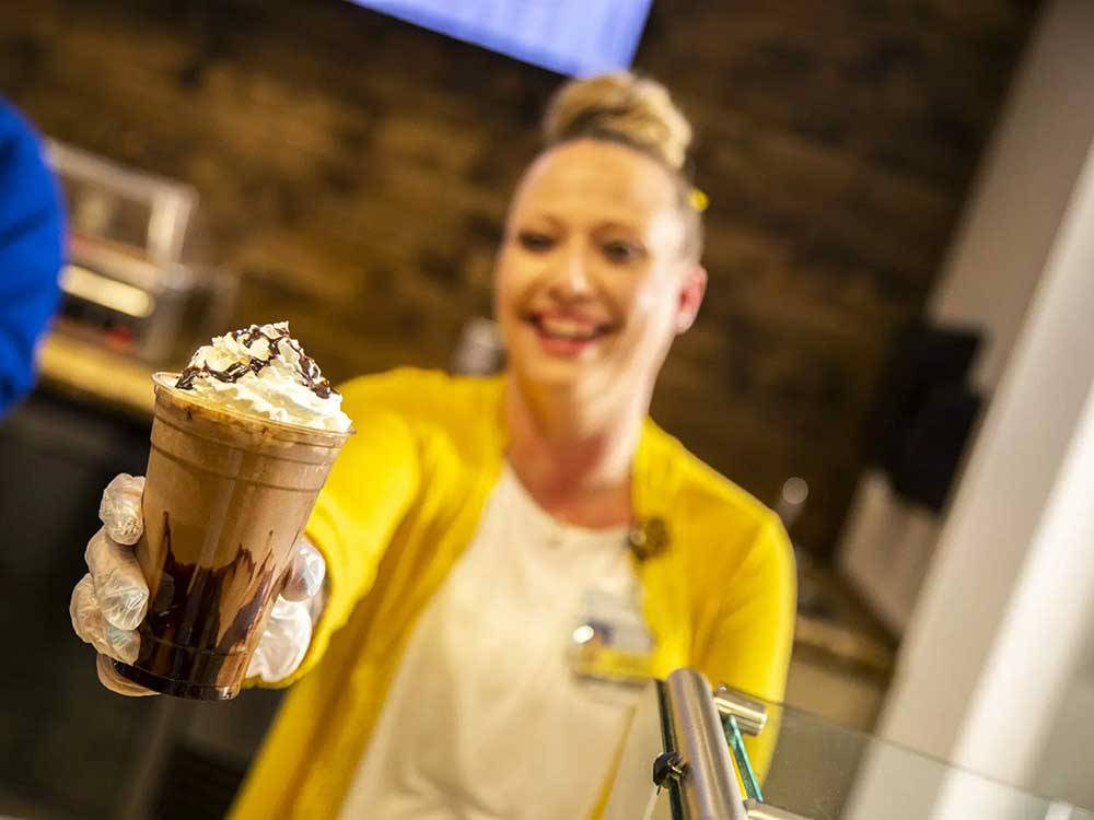 A woman serving a coffee drink at 12 TRIBES LAKE CHELAN CASINO & RV PARK