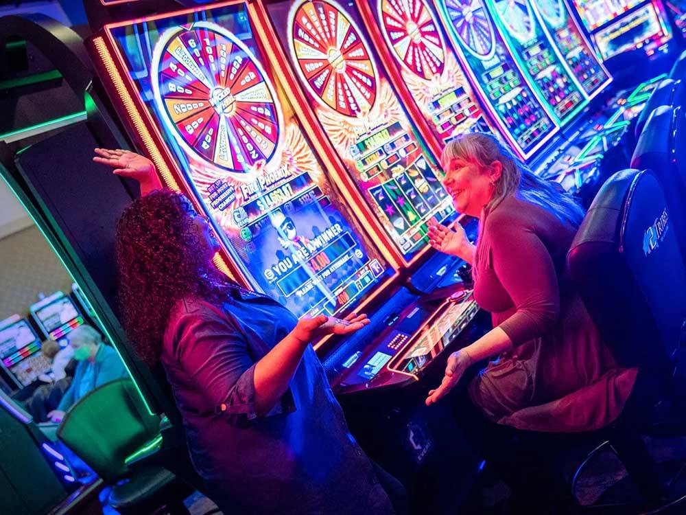Two people playing video slots at 12 TRIBES LAKE CHELAN CASINO & RV PARK