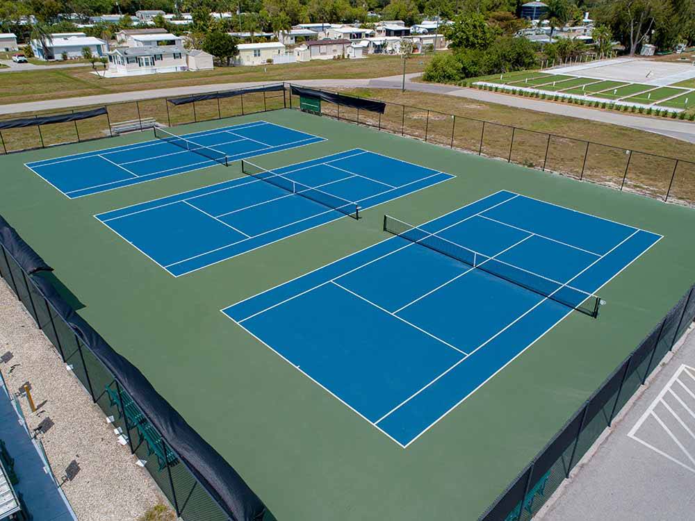 Three blue tennis courts at BONITA TERRA