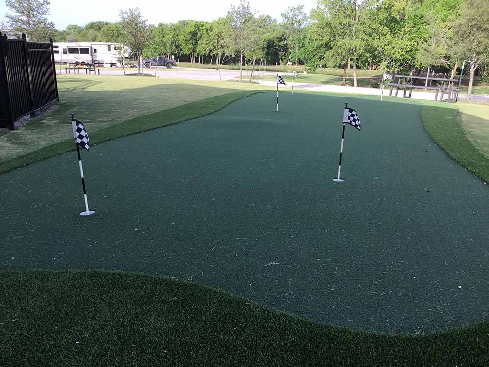 The putting green with little flags at THE RETREAT AT SHADY CREEK