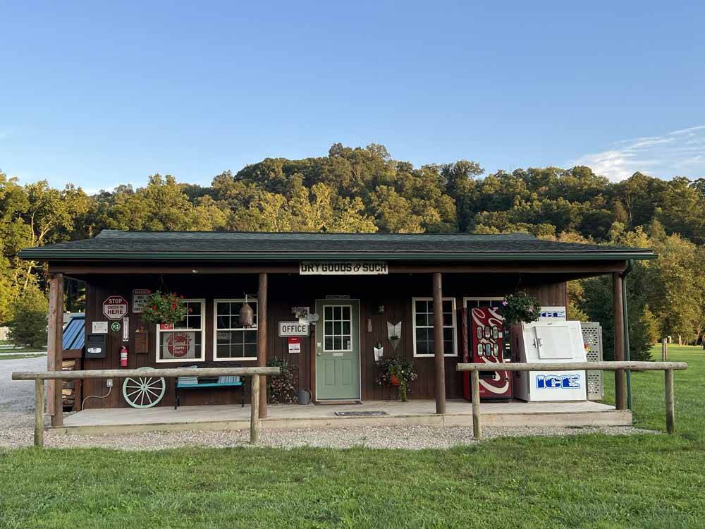 Campground building with porch, coke machine and ice at PINE CREEK CABINS AND CAMPGROUND