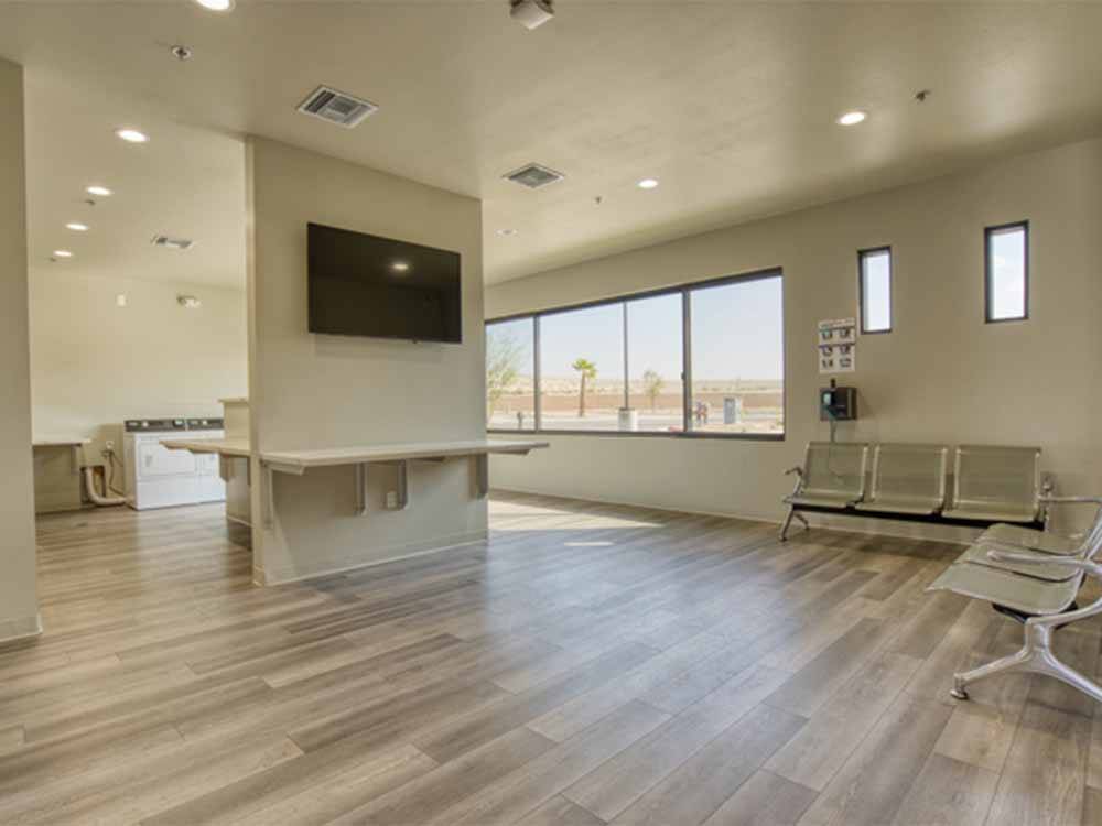 A large seating area with a flat screen TV near the laundry at COACHELLA LAKES RV RESORT