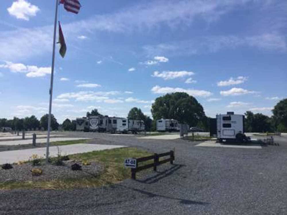 RV park with flags on a tall pole at KUMBERLAND CAMPGROUND