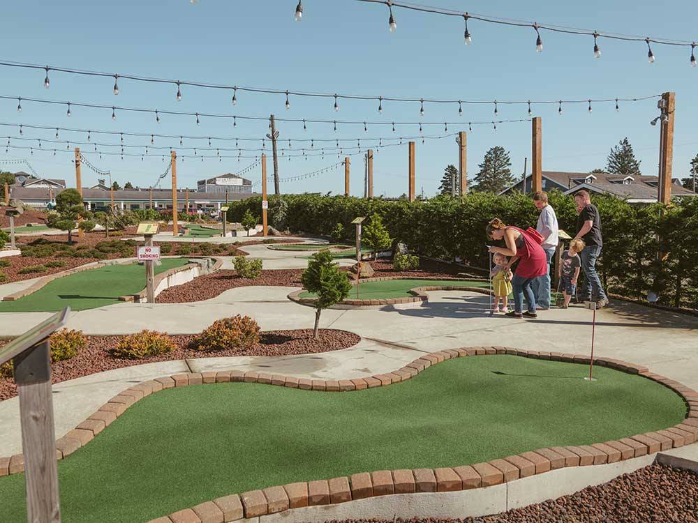 People playing on the miniature golf course at WALLICUT RIVER RV RESORT
