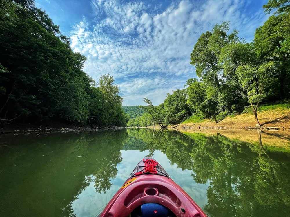 Kayak going down river, POV from paddler at PADDLE TRAIL CAMPGROUND ON THE GREEN RIVER