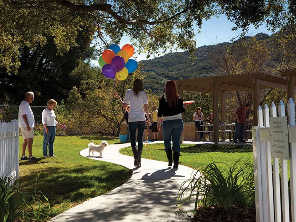 People walking towards a picnic area at PECHANGA RV RESORT