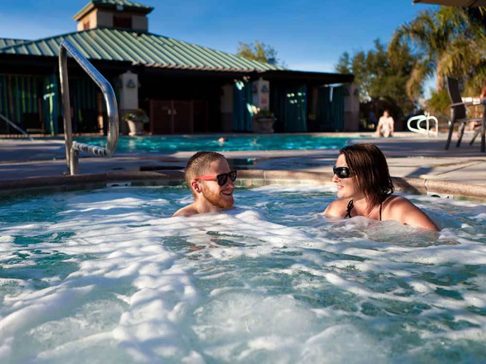 A couple relaxing in a hot tub at PECHANGA RV RESORT