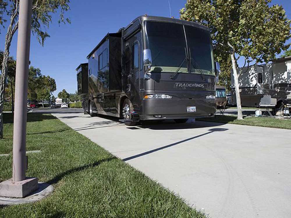 A Class A motorhome parked in one of the paved RV sites at PECHANGA RV RESORT