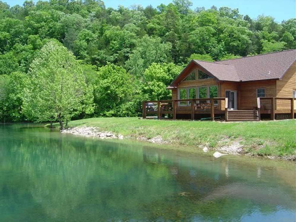 Cabin overlooking a placid pond at DENTON FERRY RV PARK & CABIN RENTAL