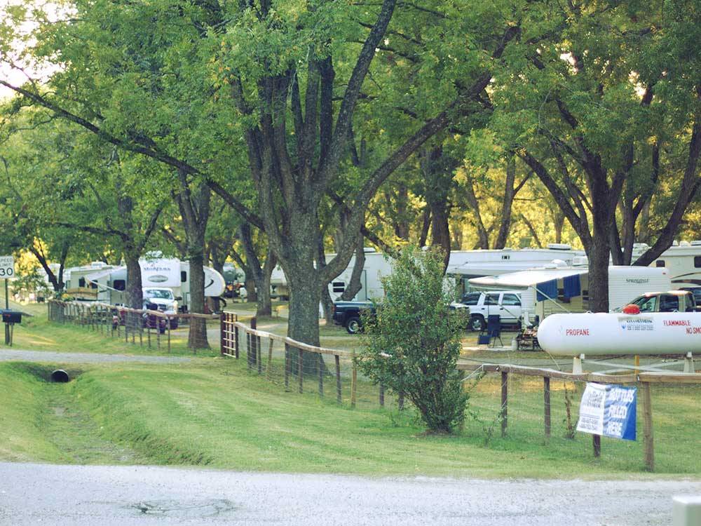 Wooden fence with RVs parked on the other side at PARK RIDGE RV CAMPGROUND