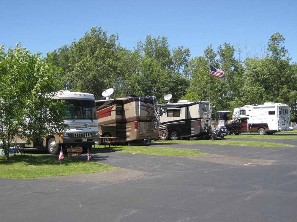 A row of motorhomes parked in sites at AA ROYAL MOTEL & CAMPGROUND