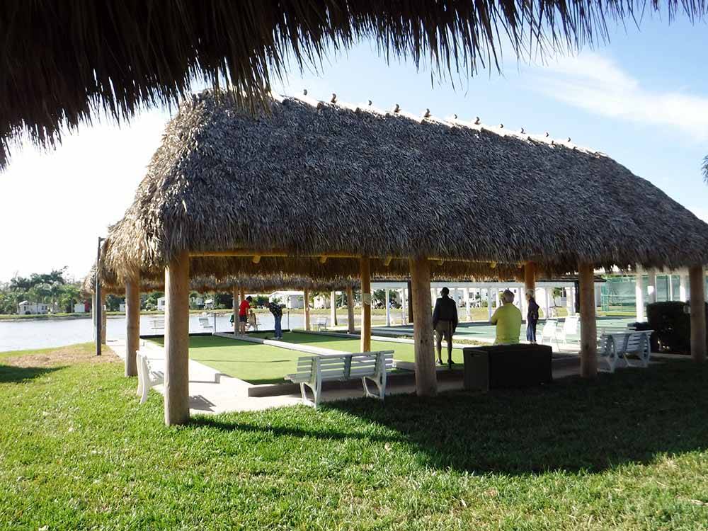 The thatch pavilion with benches at CRYSTAL LAKE RV RESORT