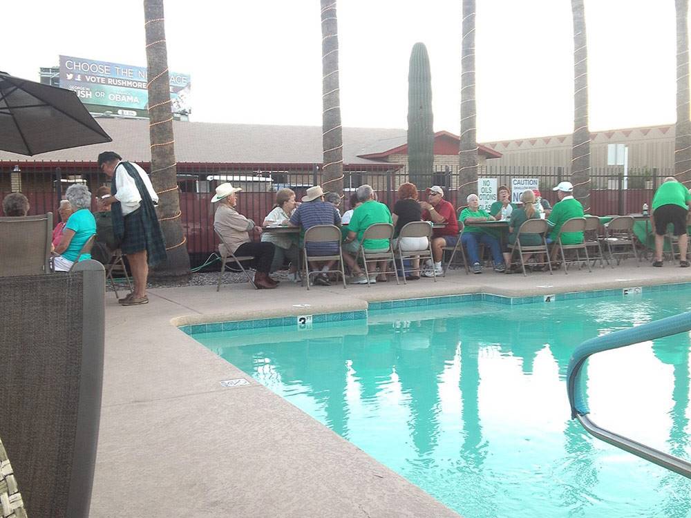 Swimming pool with outdoor seating at PHOENIX METRO RV PARK
