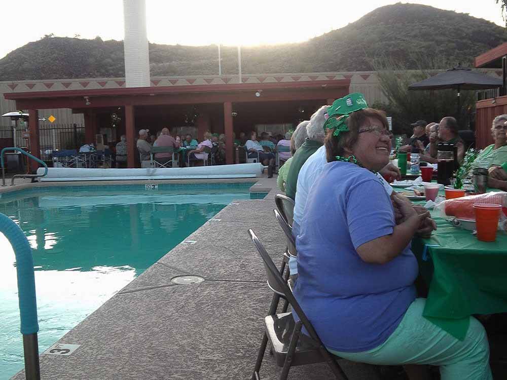 A party next to the pool at PHOENIX METRO RV PARK