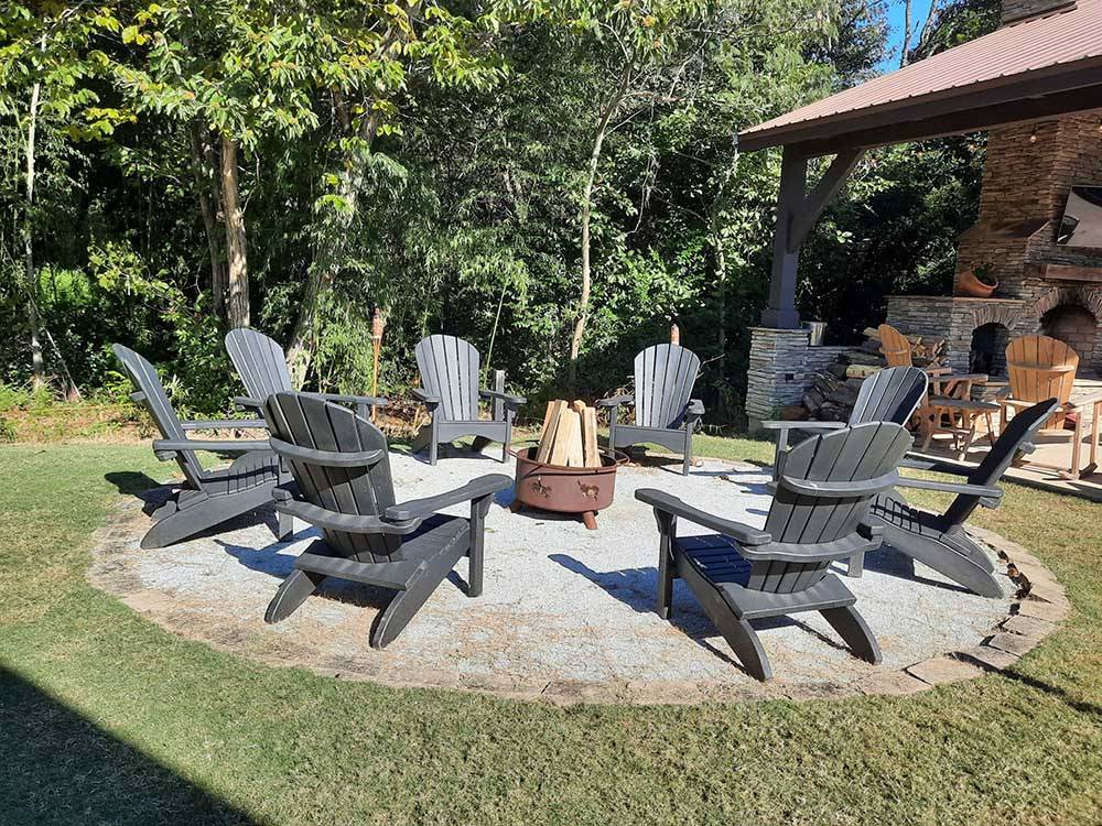 Chairs surrounding fire pit at EAGLE'S LANDING RV PARK