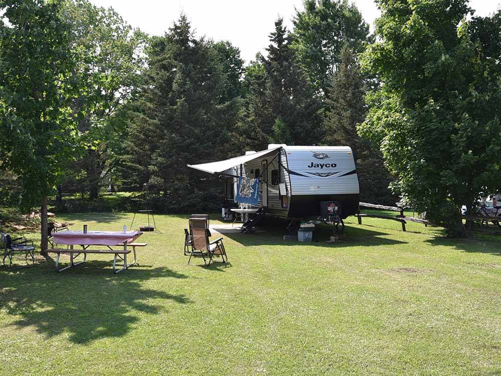 A travel trailer surrounded by grass at SAUGEEN SPRINGS RV PARK