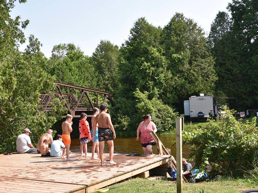 Bathers gathered near stairs leading to water at SAUGEEN SPRINGS RV PARK