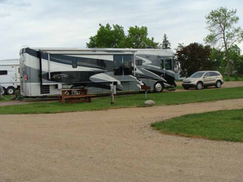 A motorhome in a pull thru RV site at COUNTY LINE RV PARK & CAMPGROUND
