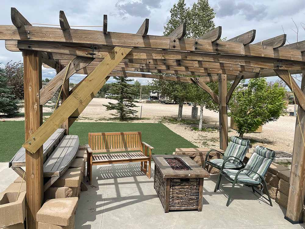 A pergola with a fire pit table at RIVER'S EDGE RV RESORT