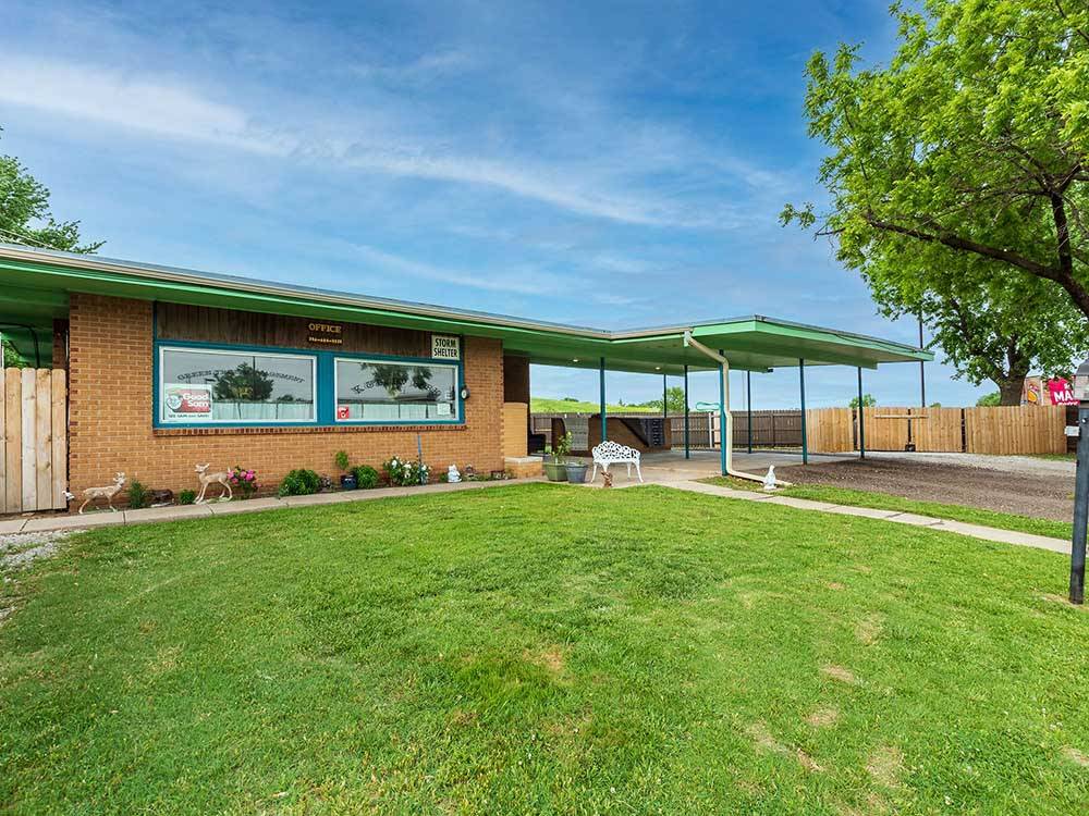 Brick campground office surrounded by green lawn at K & R RV PARK