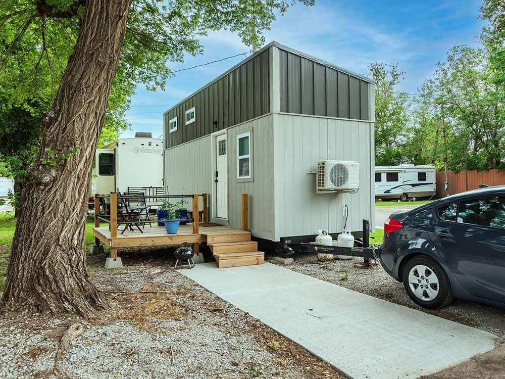 Bunkhouse park model with wooden patio at K & R RV PARK